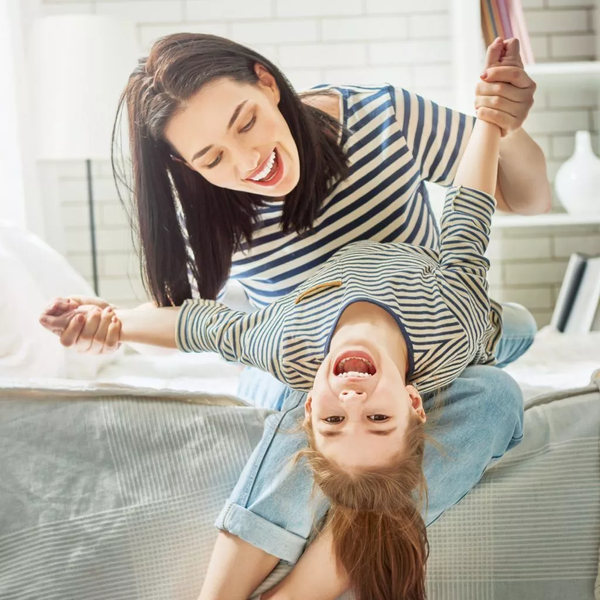 Mother and Daughter Wearing Stripe Shirt Playing and Smiling